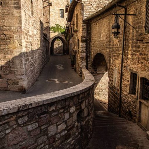 Steep cobbled lane with worn stone paving in an Italian hill town
