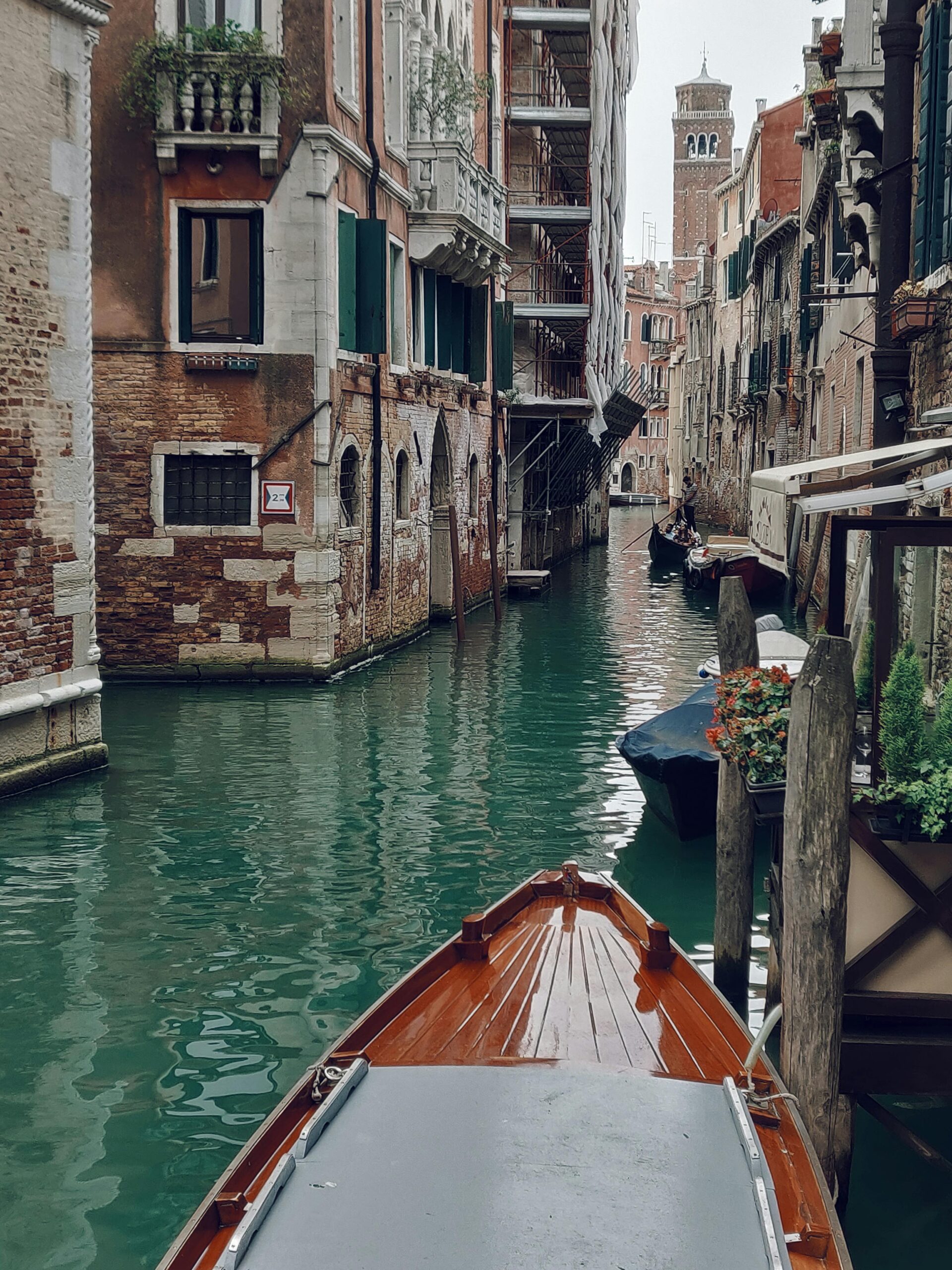 Explore the charm of Venetian canals with historic architecture and gondolas