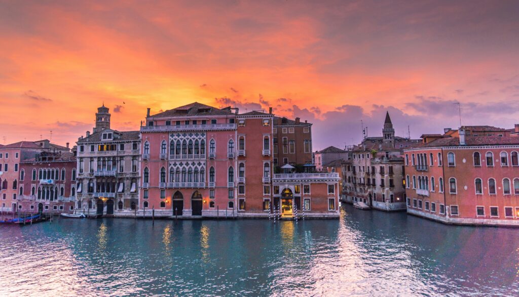 Captivating view of Venice's Grand Canal during sunset showcasing historic architecture and serene waters.