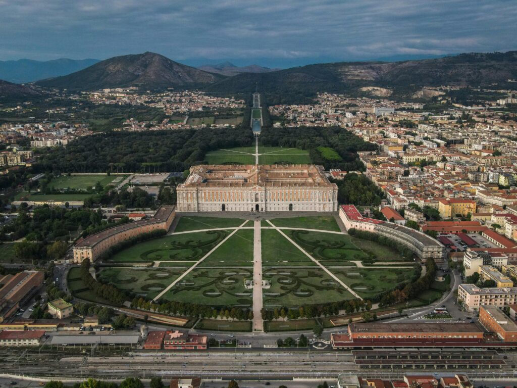 Stunning aerial photograph of the Royal Palace of Caserta and its expansive gardens.