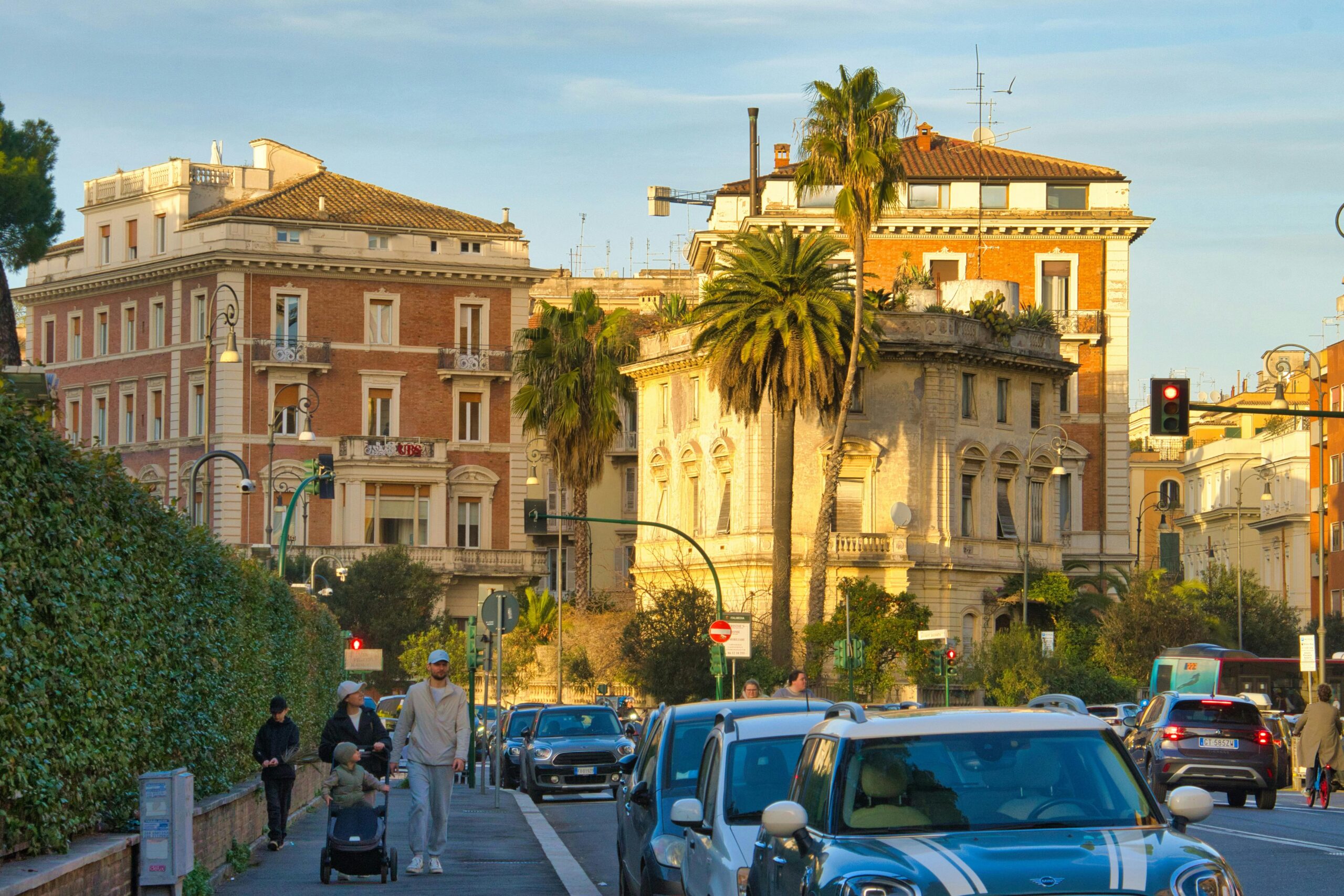 Traffic and pedestrians on a busy street in central Rome