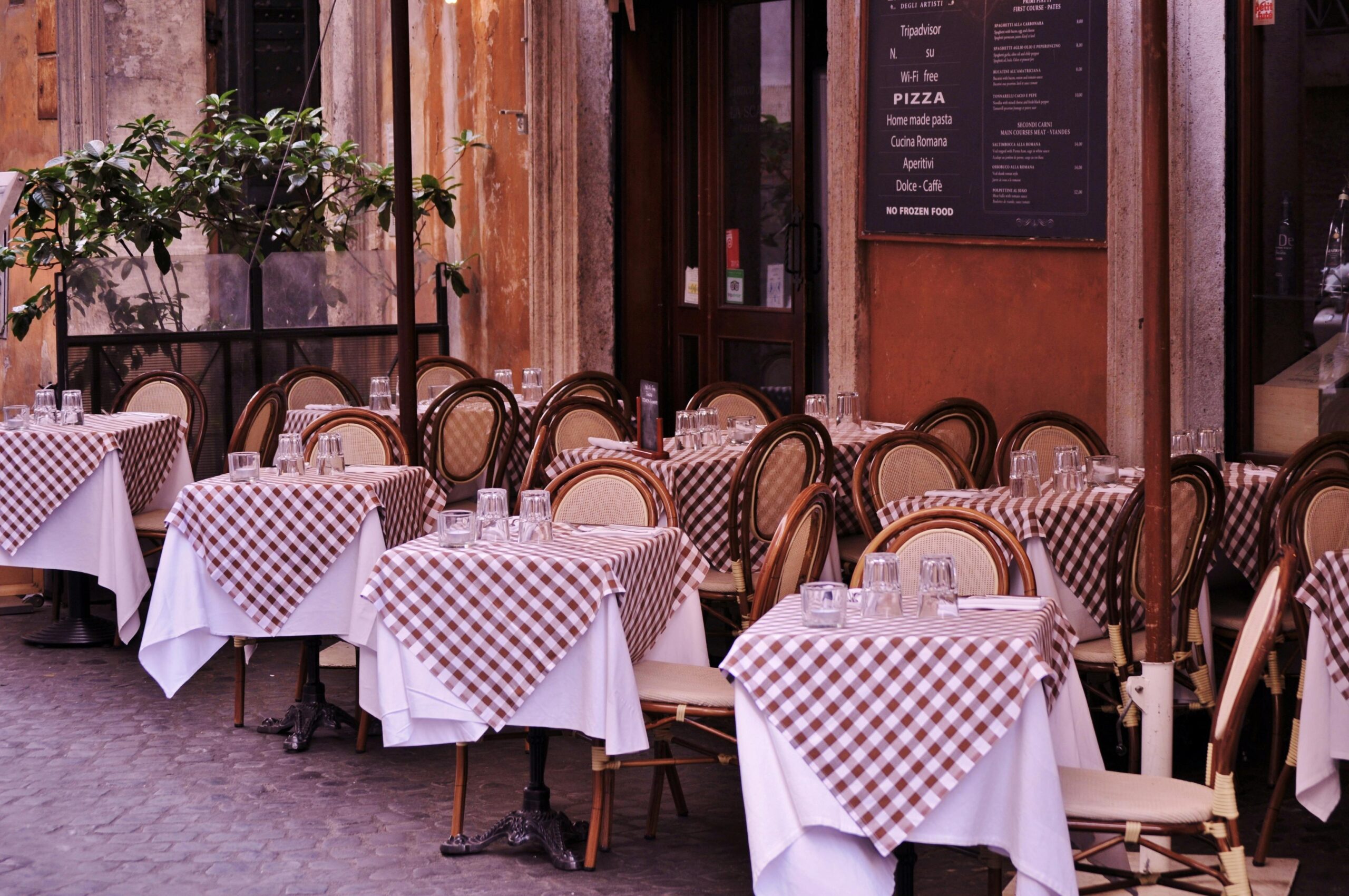 Italian restaurant with checkered tablecloths and outdoor seating