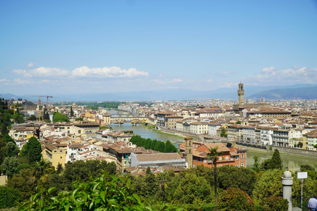 A breathtaking view of Florence, Italy showcasing its iconic architecture, lush greenery, and Arno River.