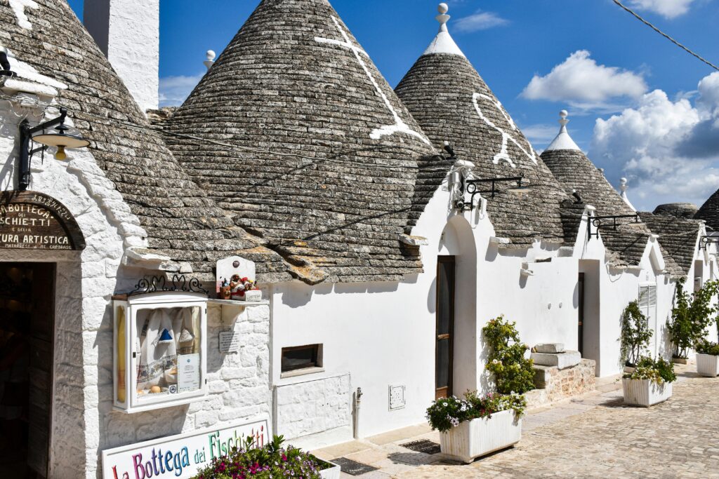 Charming white Trulli houses with conical roofs in Alberobello, Apulia, Italy.