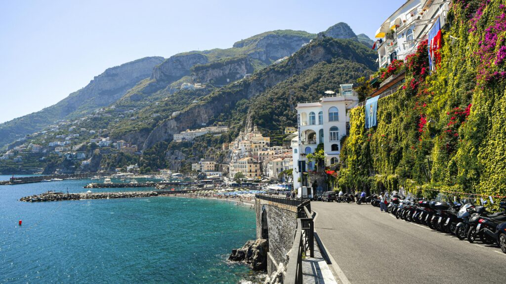 Capture the breathtaking beauty of the Amalfi Coast with its stunning cliffs and vibrant waters.