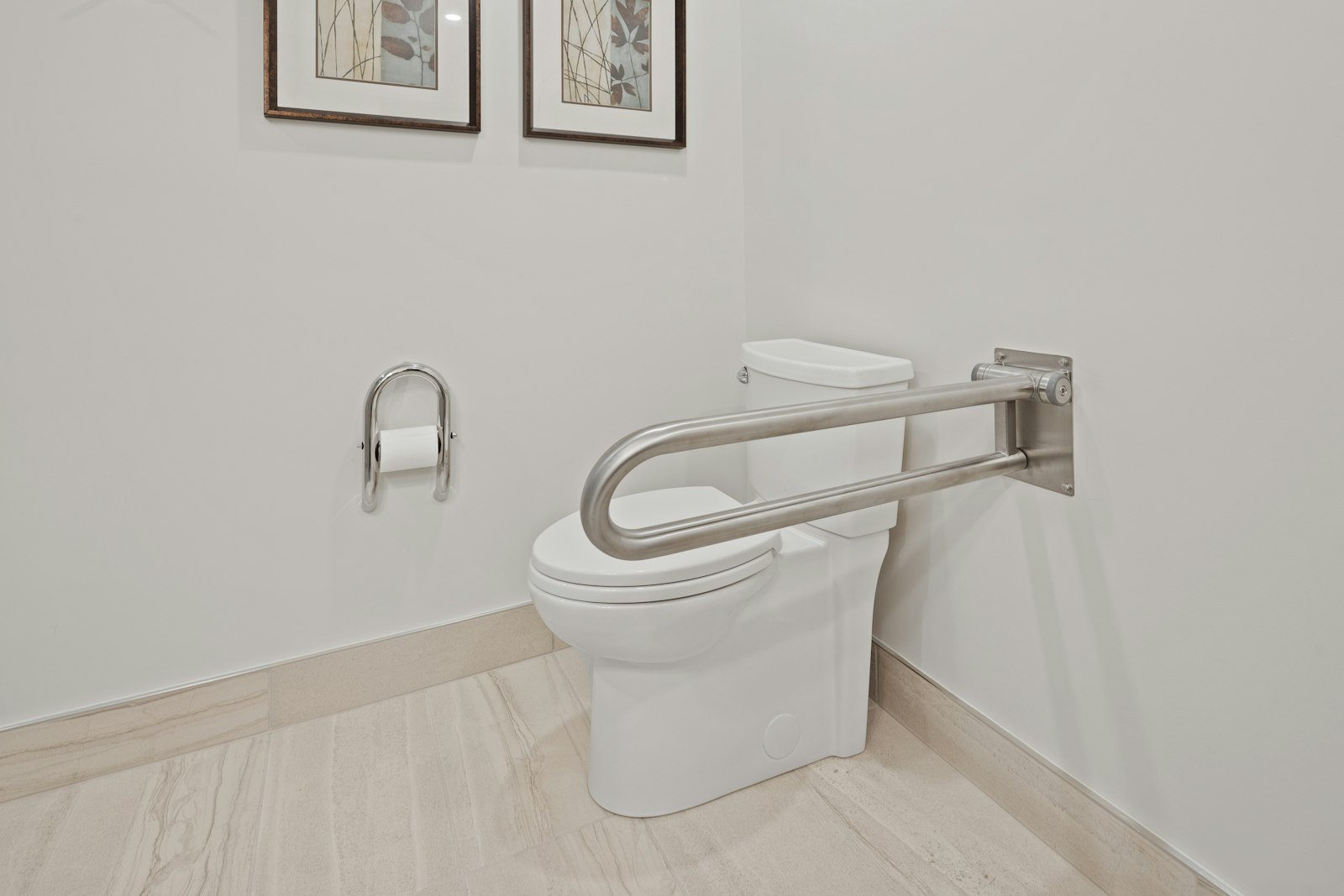 Accessible bathroom with a metal grab rail beside the toilet