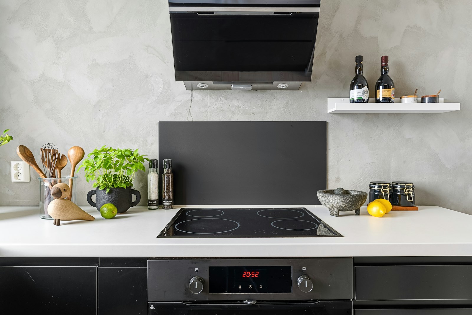 Modern apartment kitchen with a flat cooktop and built-in oven