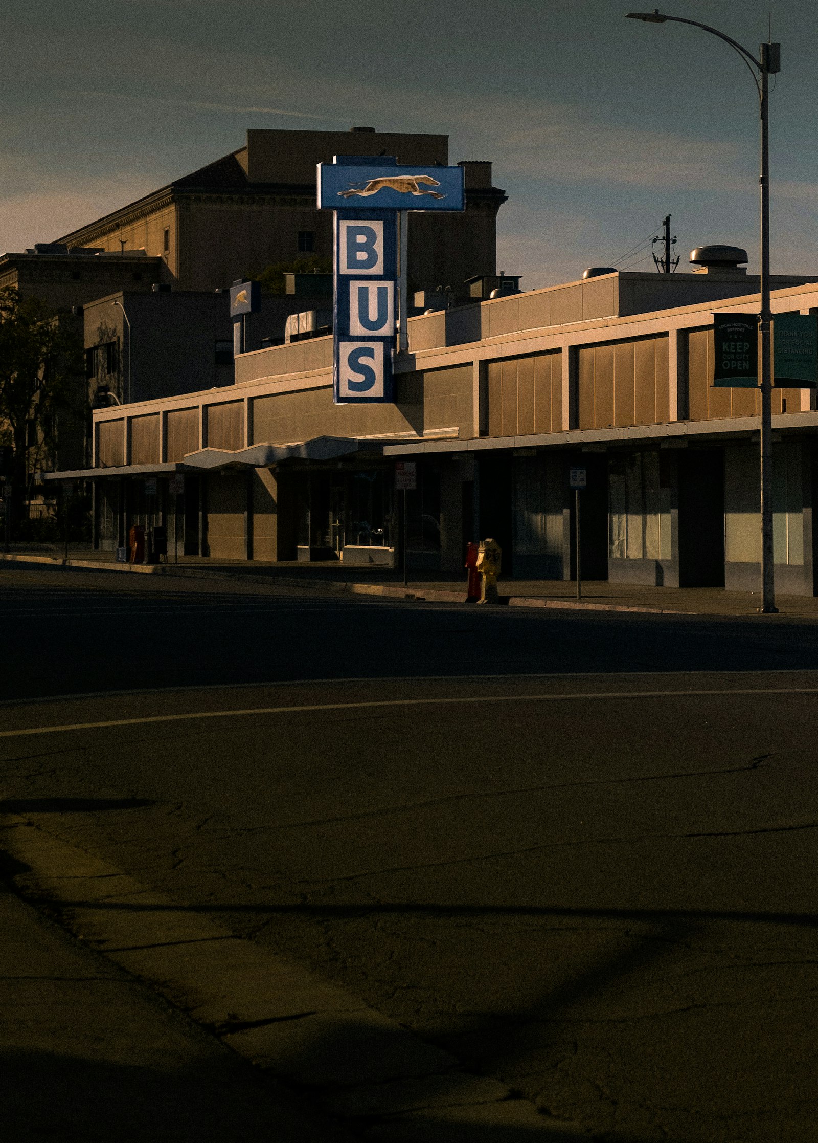 Bus stop sign listing the route numbers that use the bay