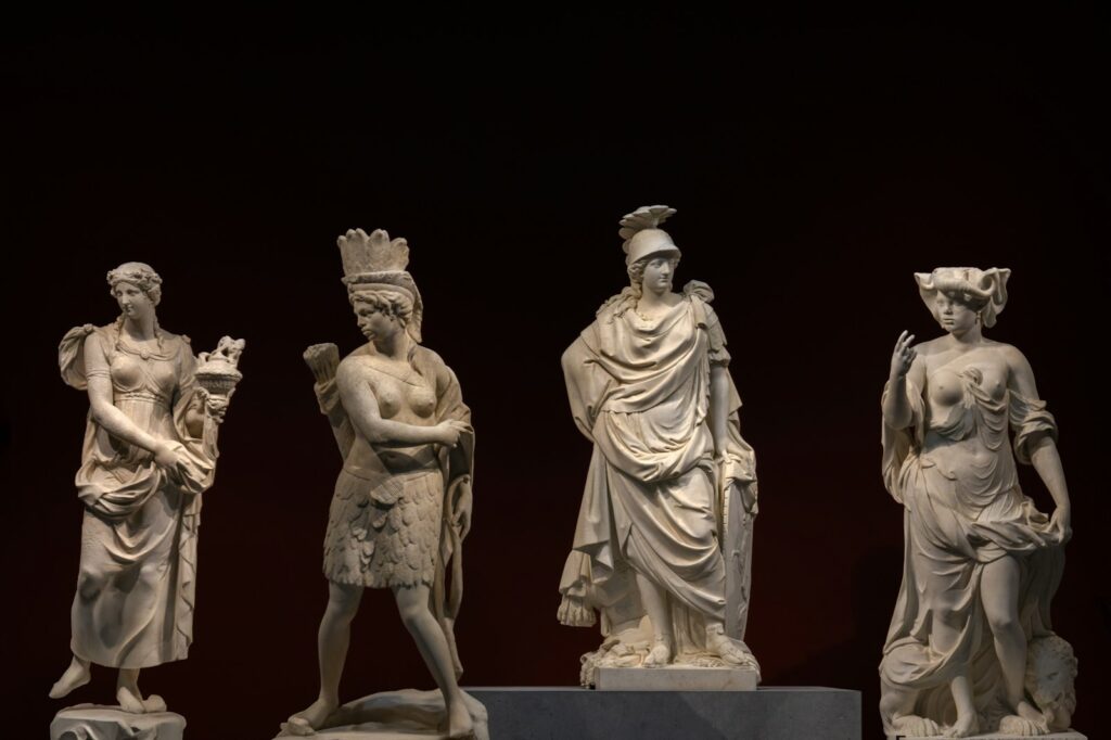 Classical marble statues displayed in a museum gallery