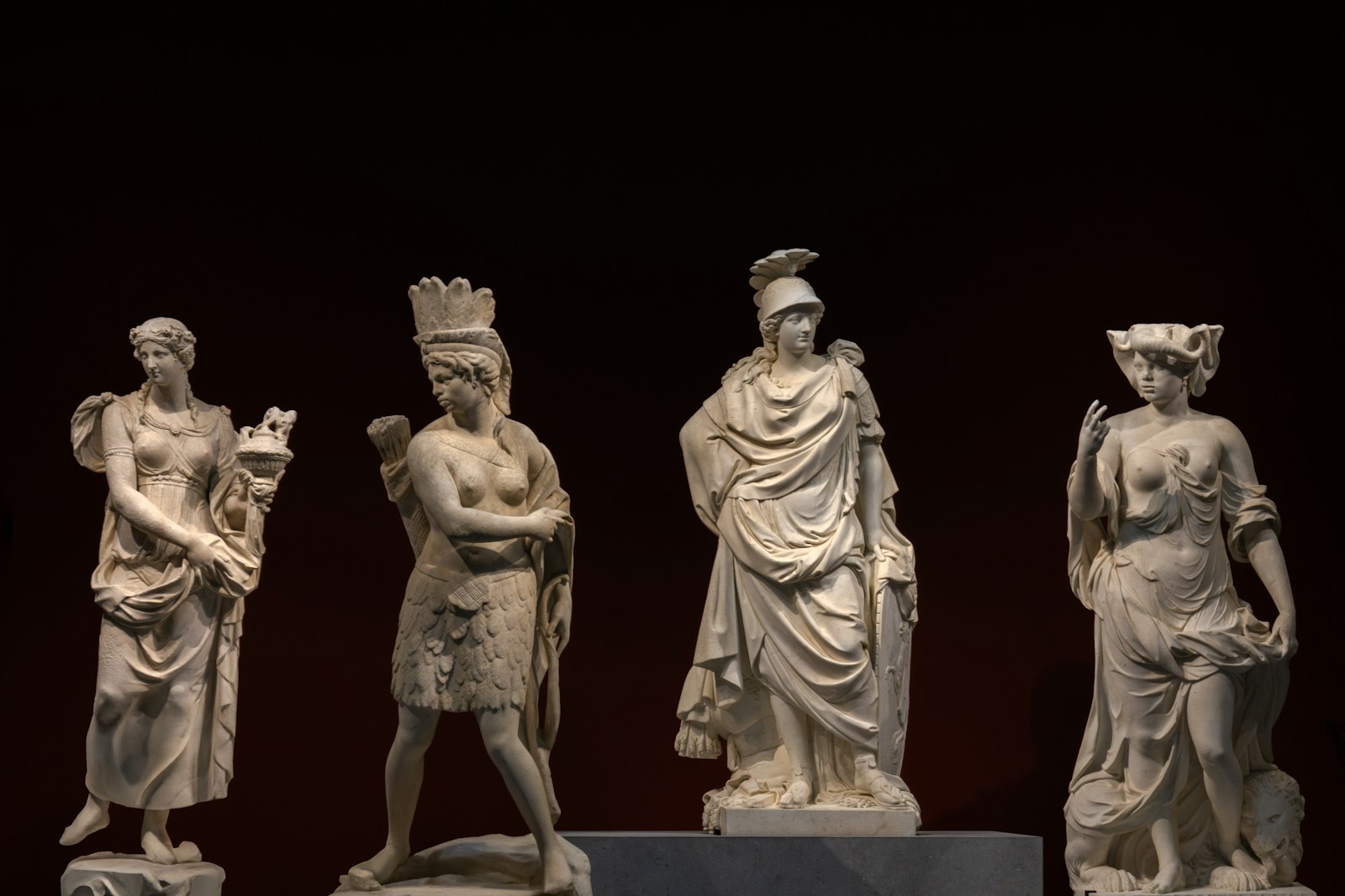 Classical marble statues displayed in a museum gallery
