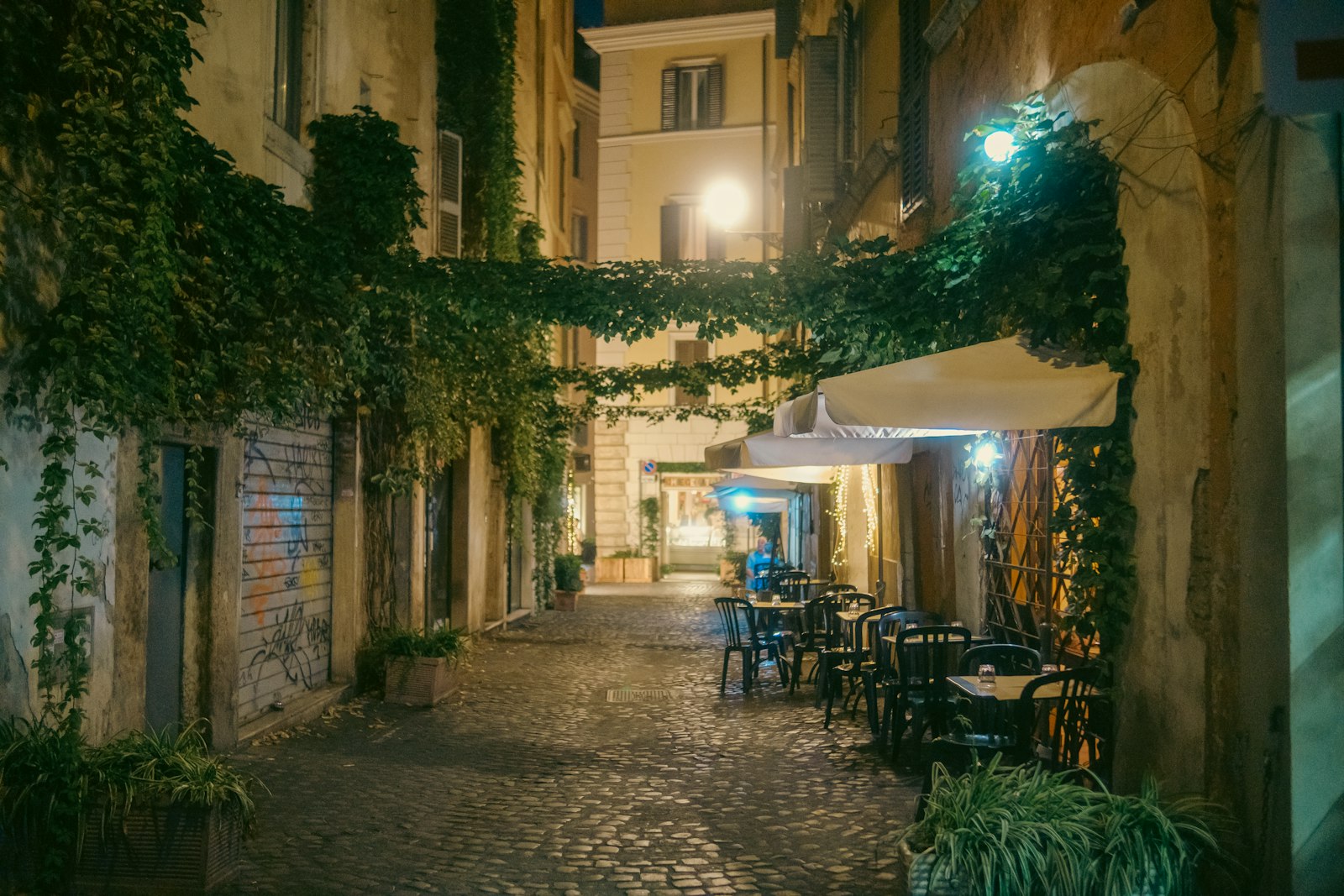 Cobbled street with cafe tables in the Trastevere district of Rome