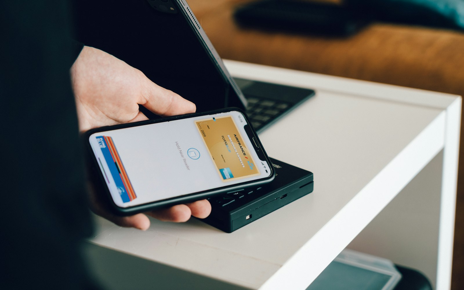 Traveler paying contactlessly with a smartphone at a card reader in Italy