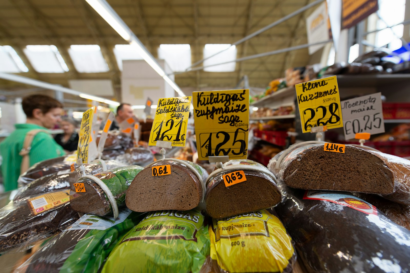 Packaged food products displayed with price labels on a shop shelf