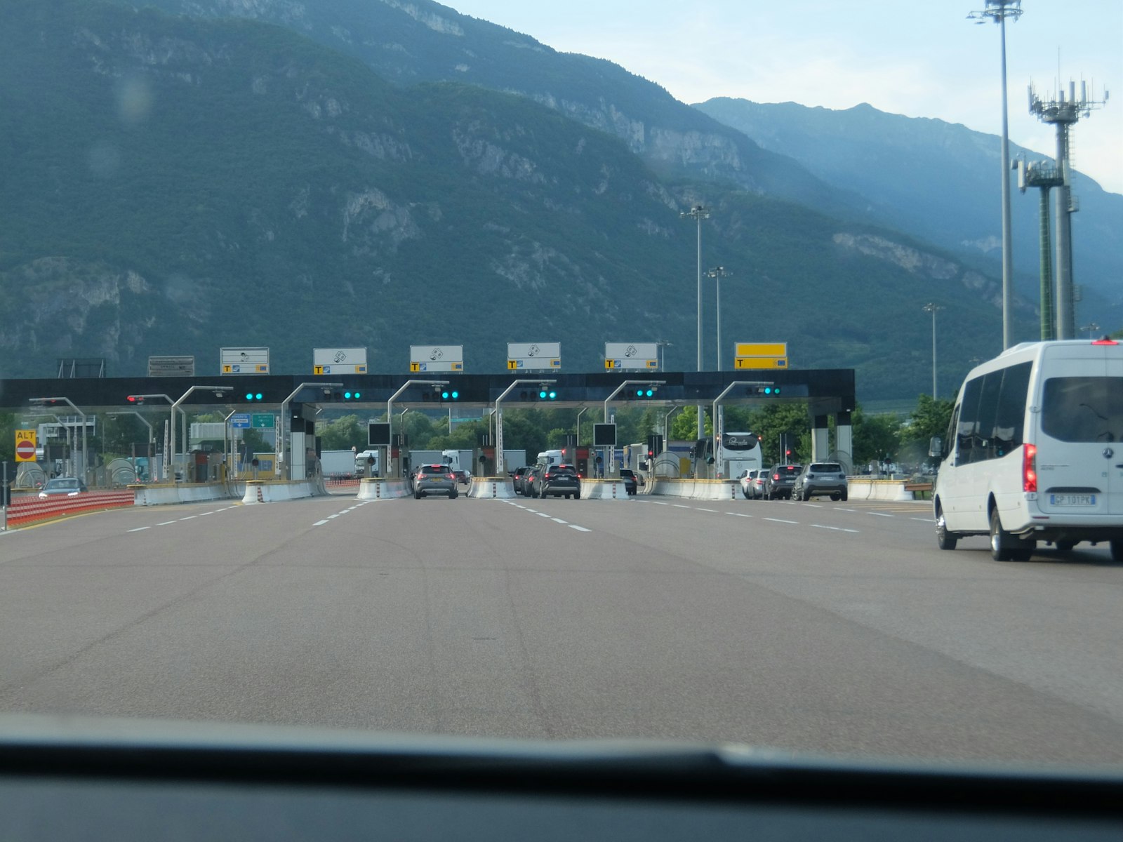 Cars approaching a multi-lane toll plaza on an Italian autostrada