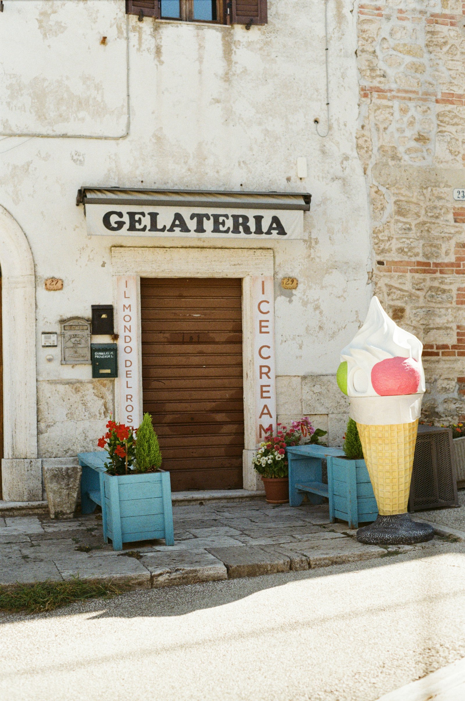 Rustic Italian gelateria storefront with a large ice cream sign