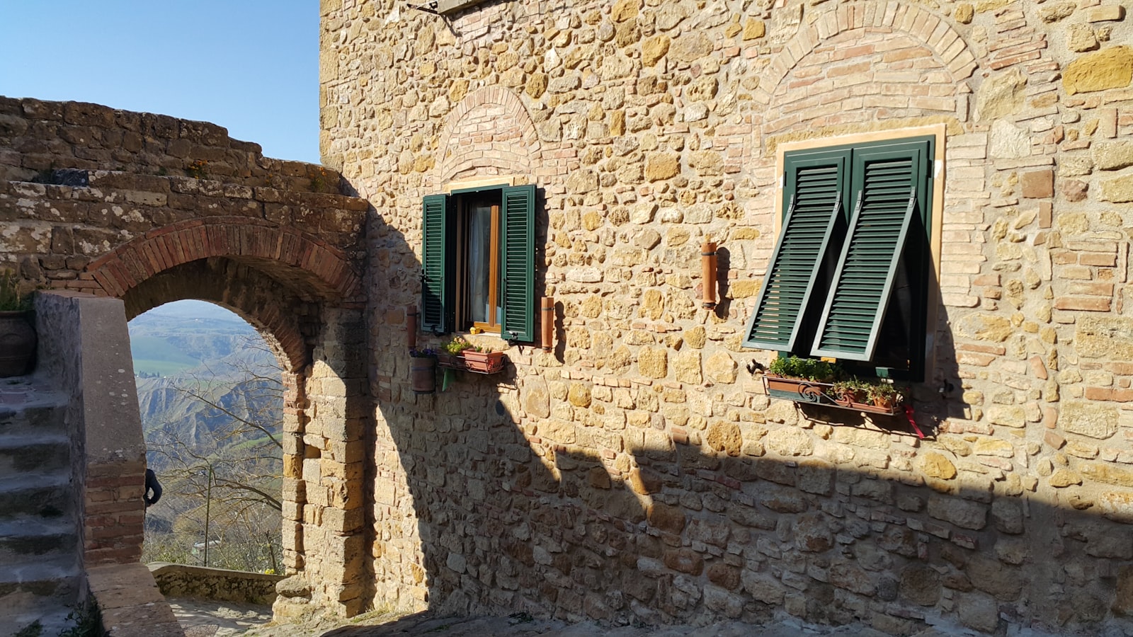 Close-up of dark wooden louvered window shutters on an Italian building