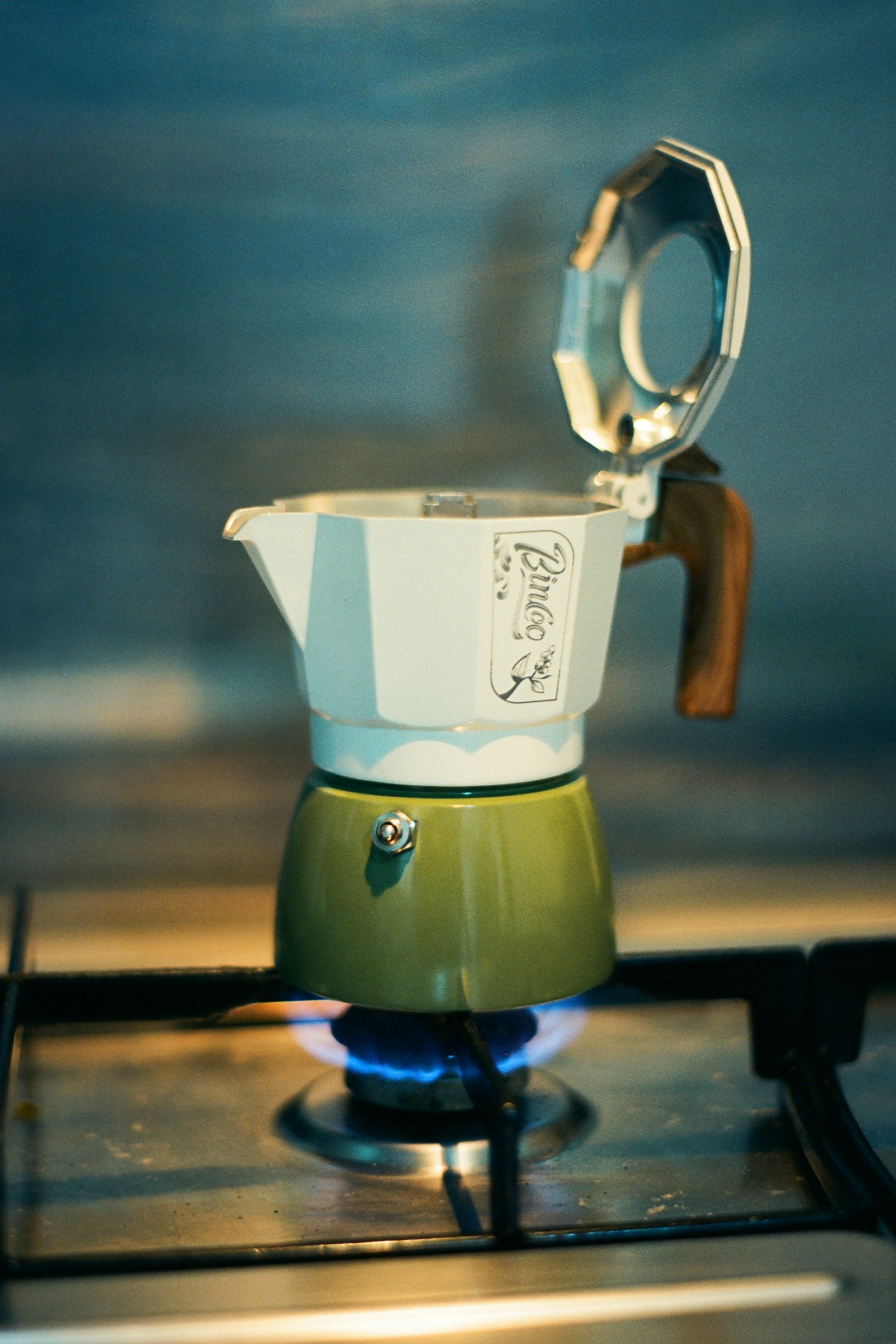 Aluminium moka pot heating on a stovetop burner