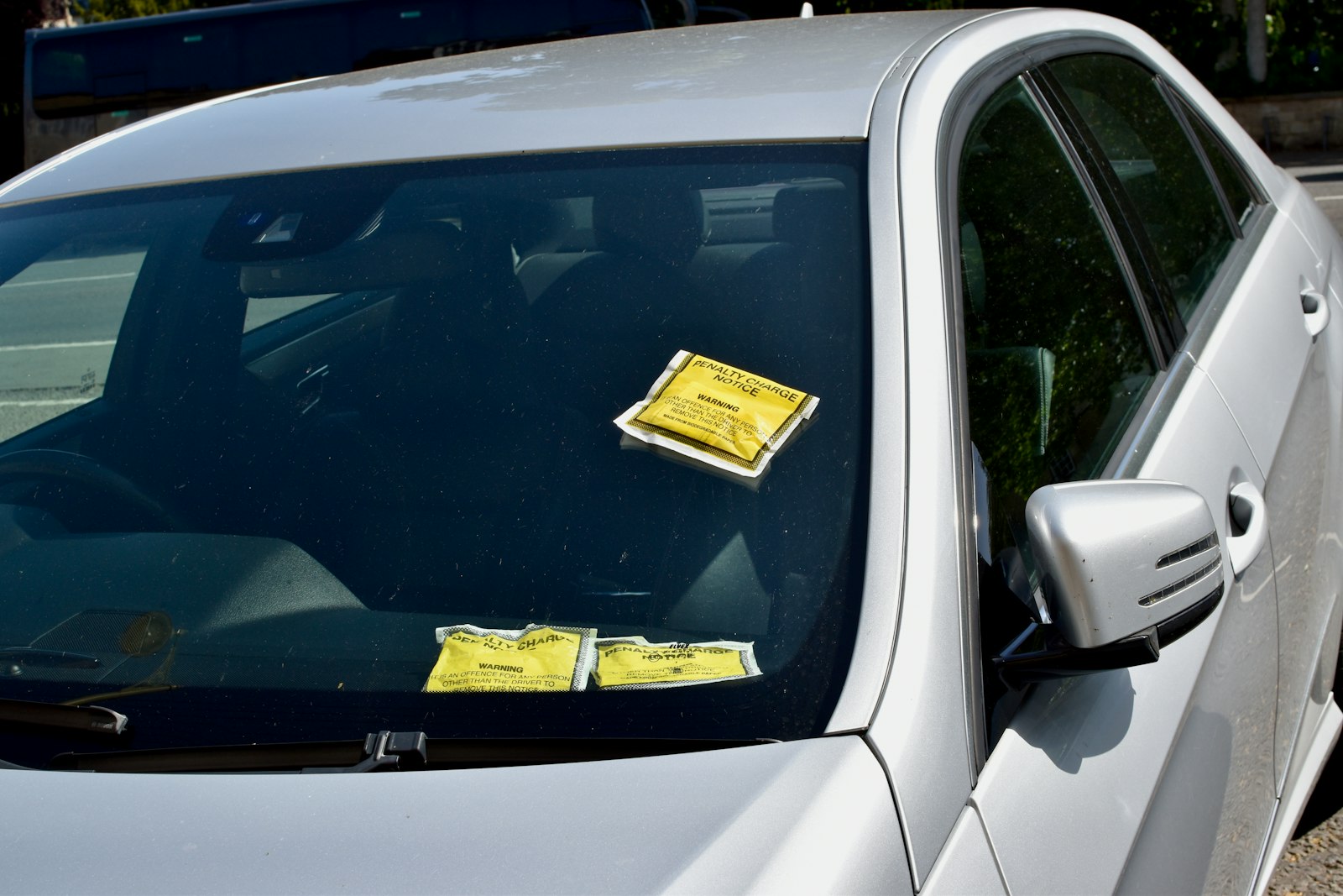 Parking notice left under a car windscreen wiper after an overstay
