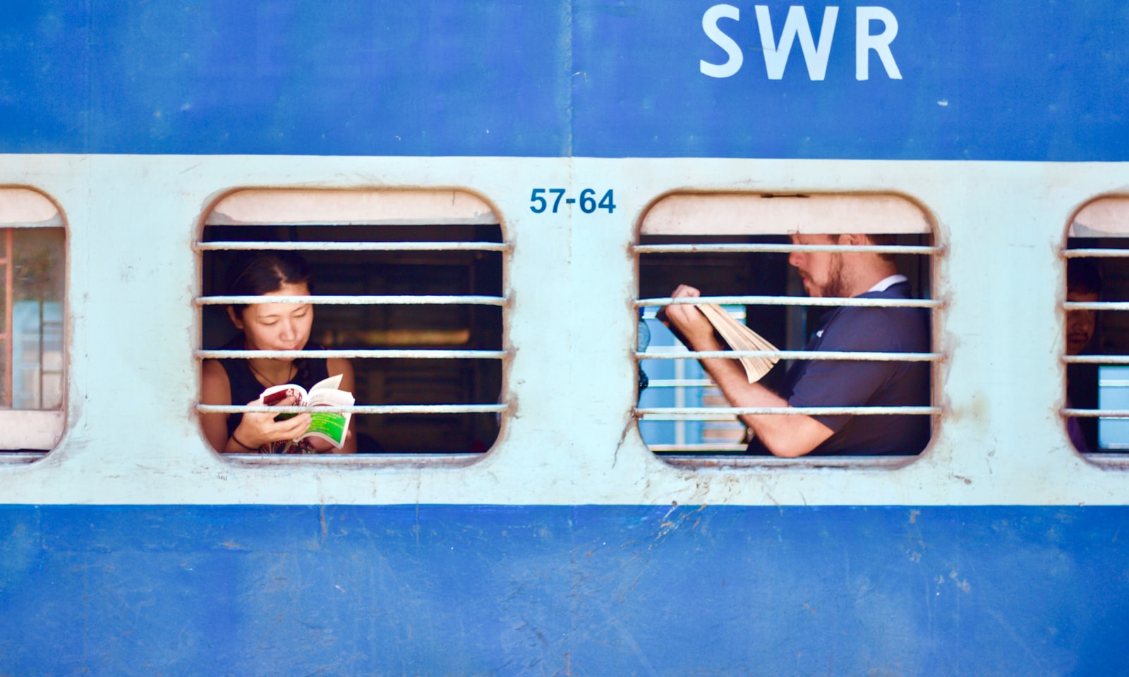 Two passengers sitting together on a train