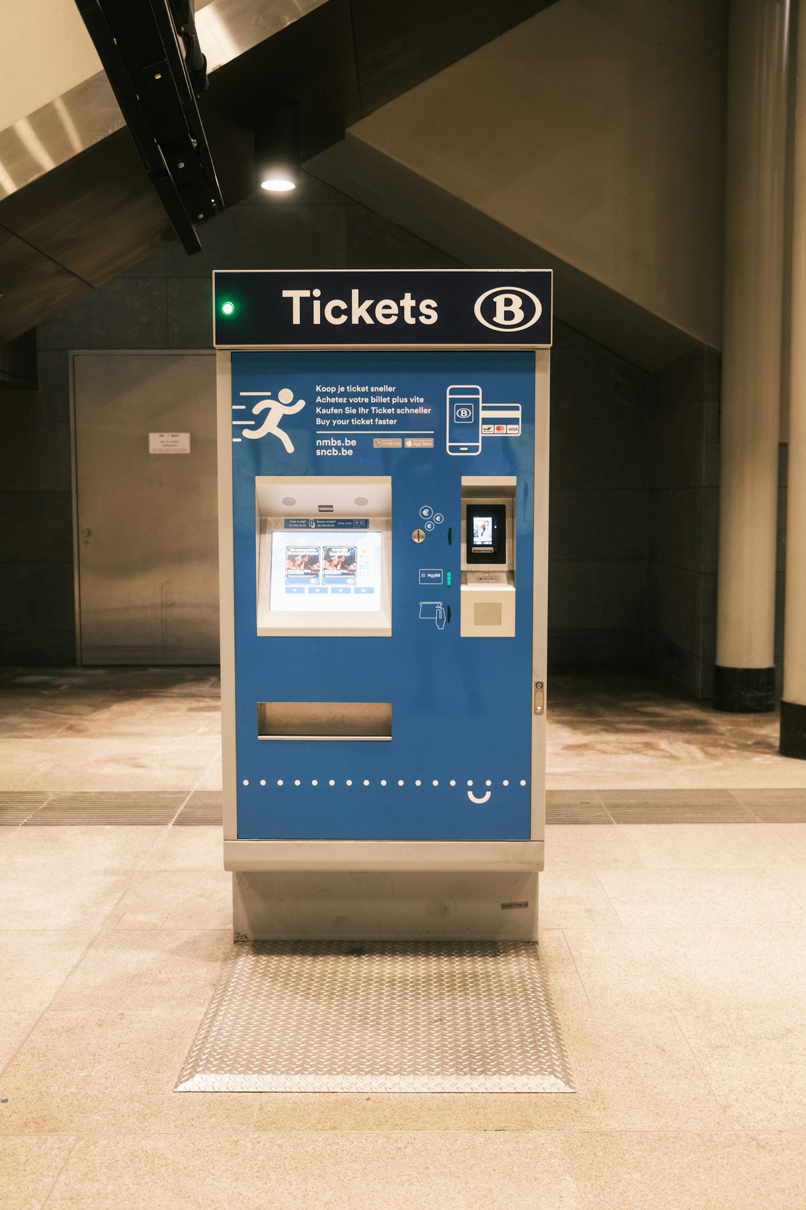 Queue ticket machine standing inside a shop