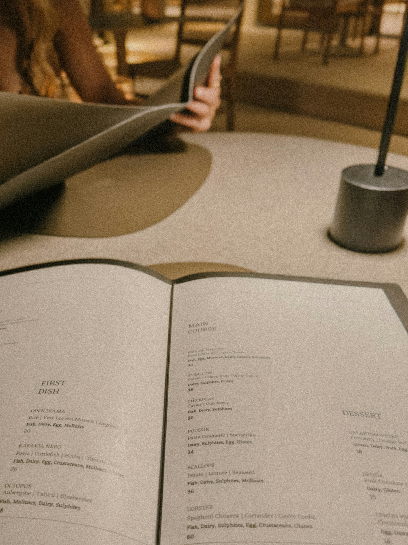 Diner reading a restaurant menu closely at the table