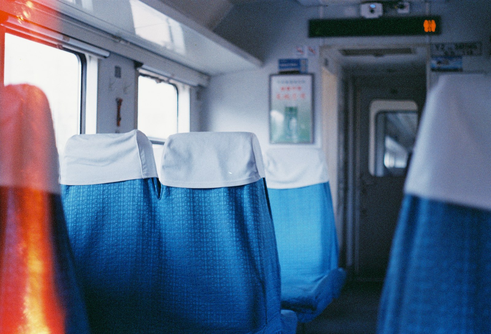 Rows of reserved blue seats inside a train carriage