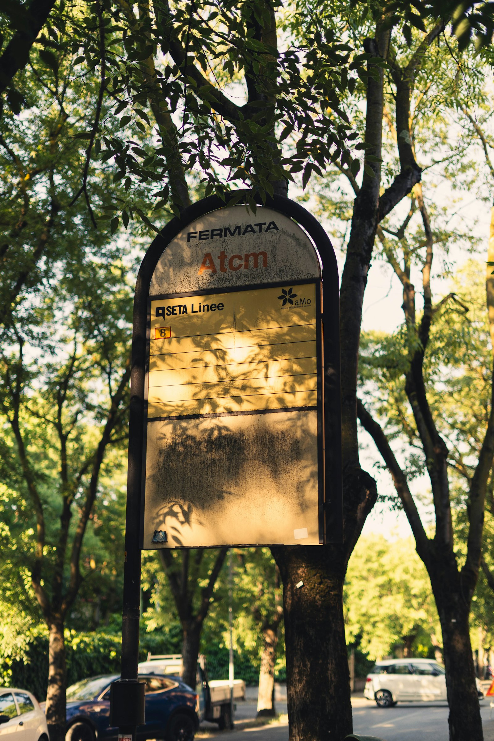 Roadside bus stop sign showing the line and direction