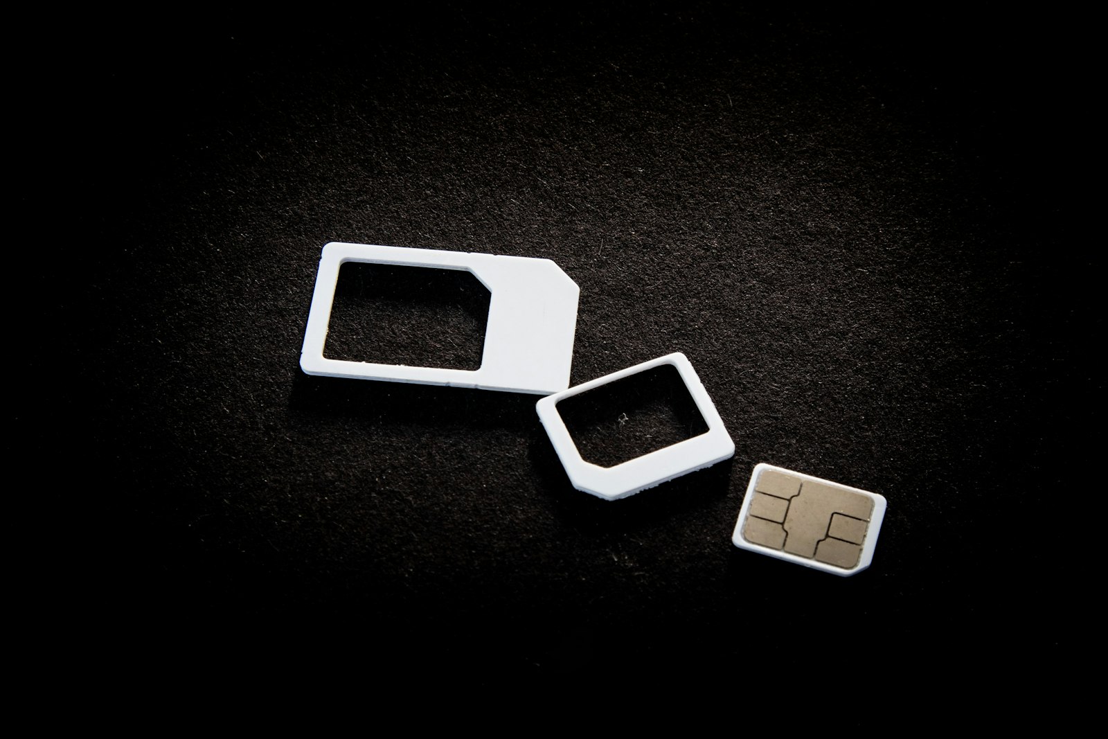 Selection of SIM cards and adaptors laid out on a display