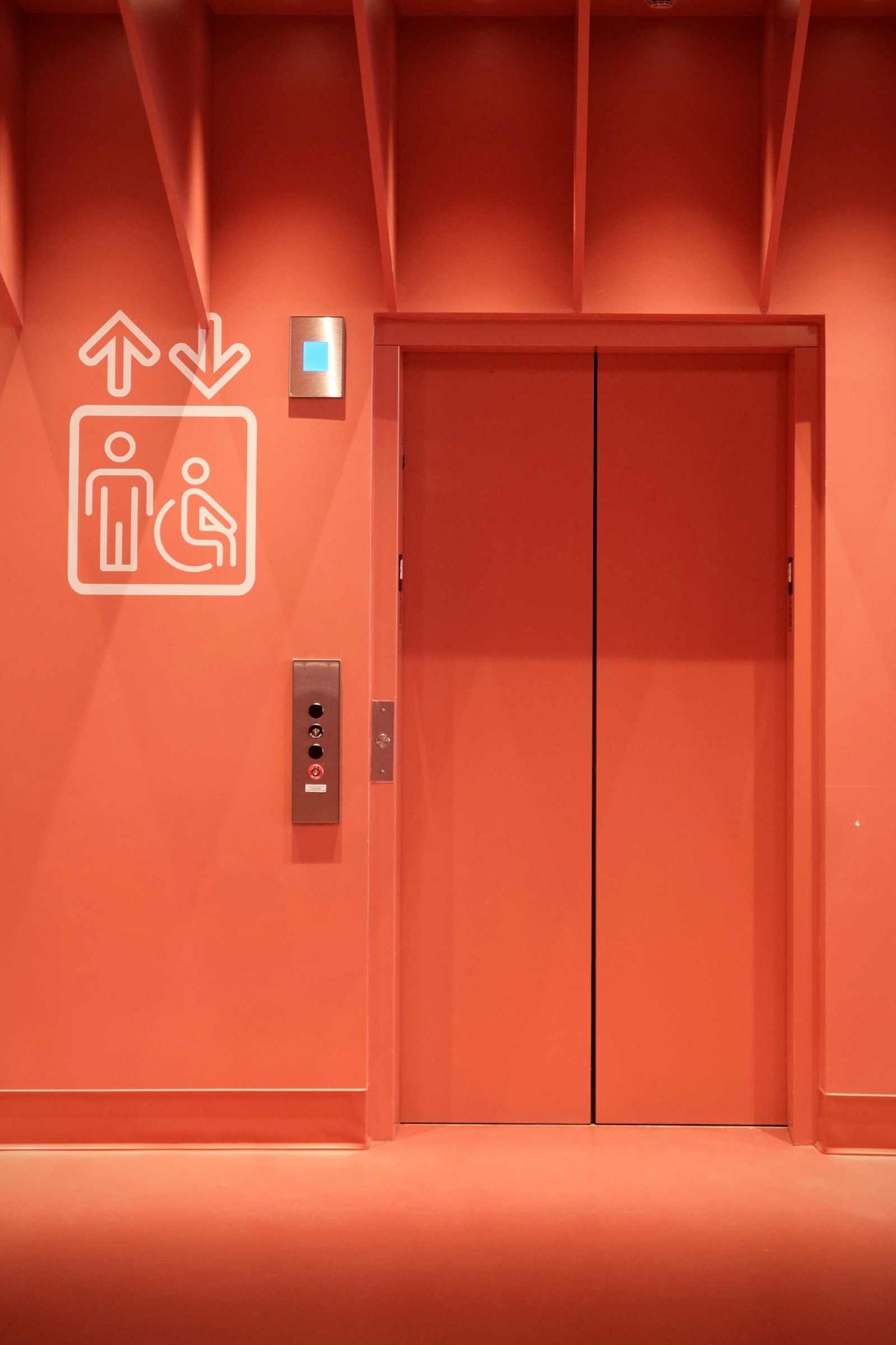 Lift doors marked with an accessibility symbol