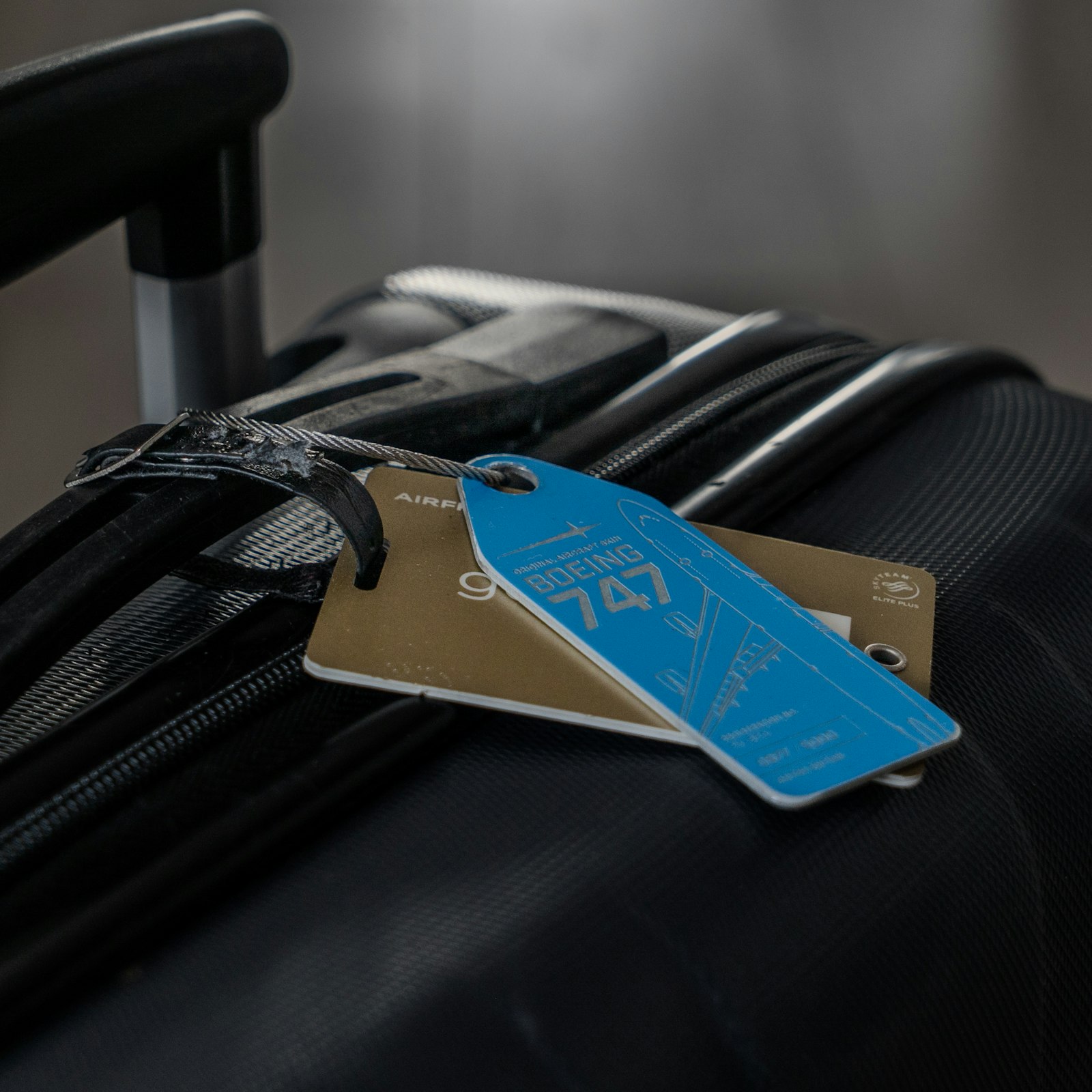 Suitcase with a luggage tag attached to the handle