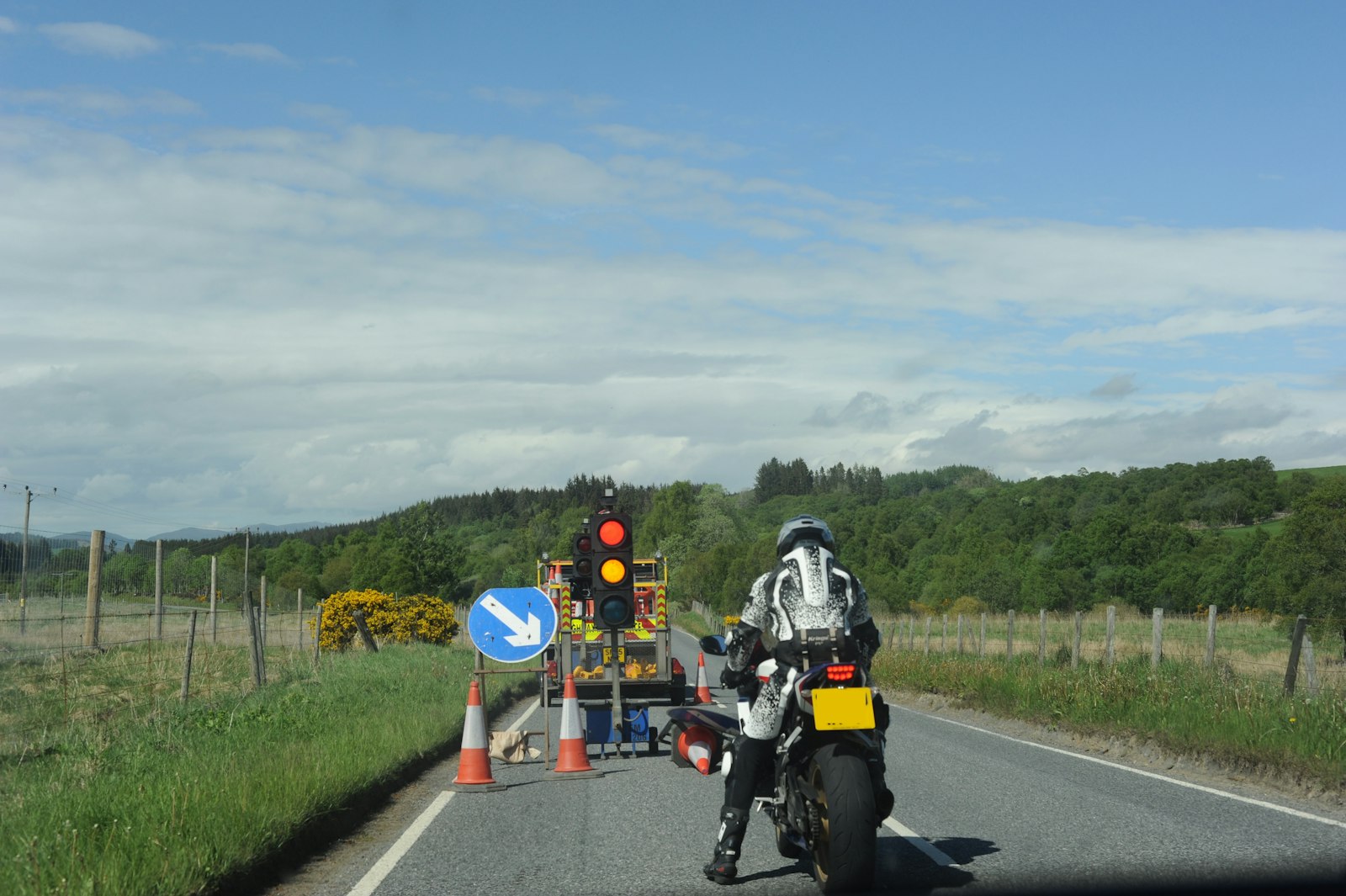Temporary red traffic light controlling alternating traffic at roadworks