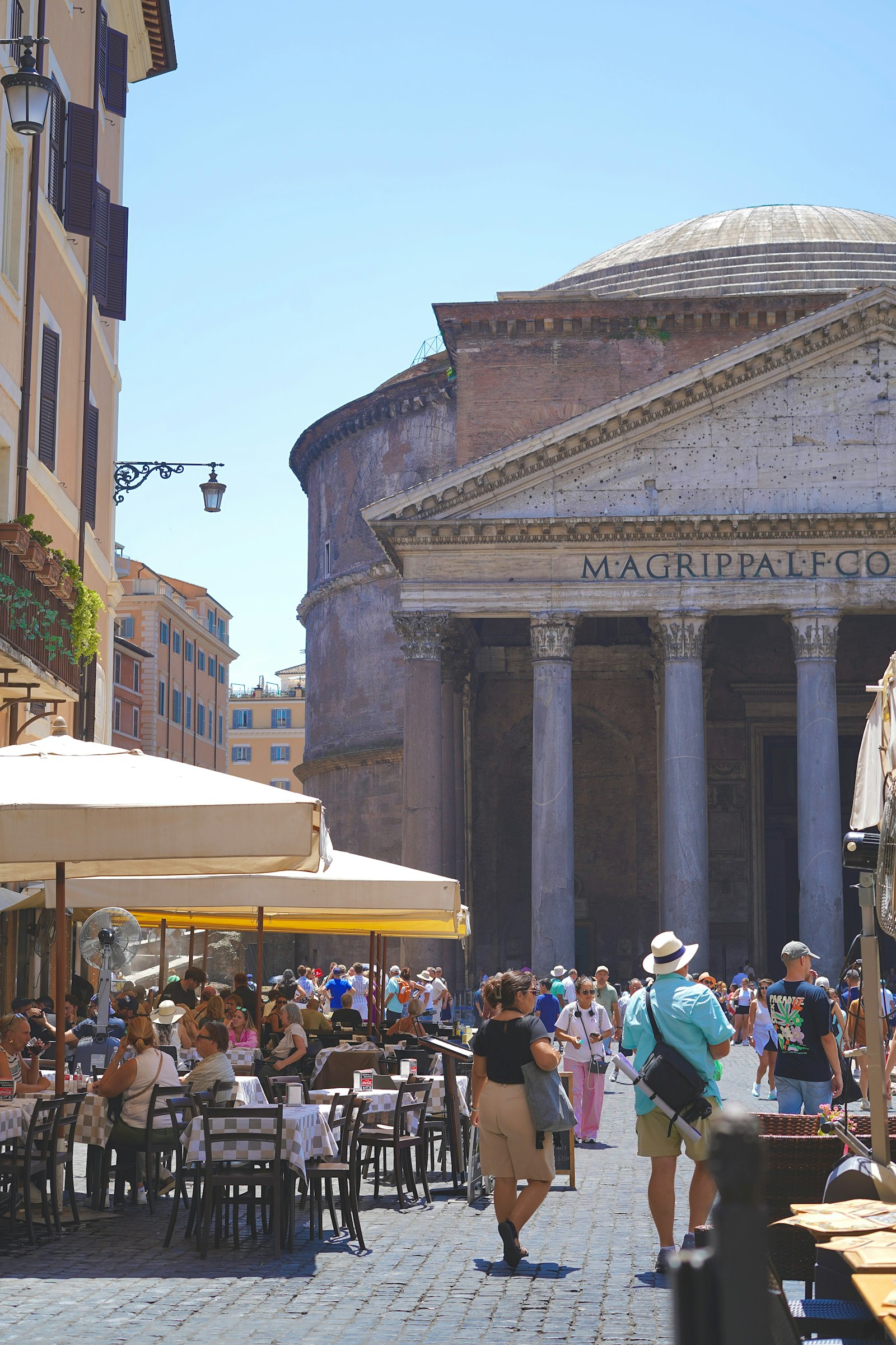 Tourists and cafe tables in the square outside the Pantheon in Rome