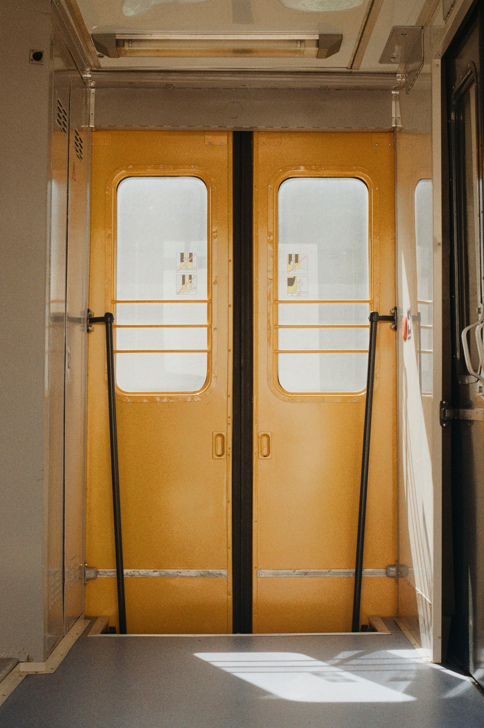 Interior of a train carriage looking towards the doorway