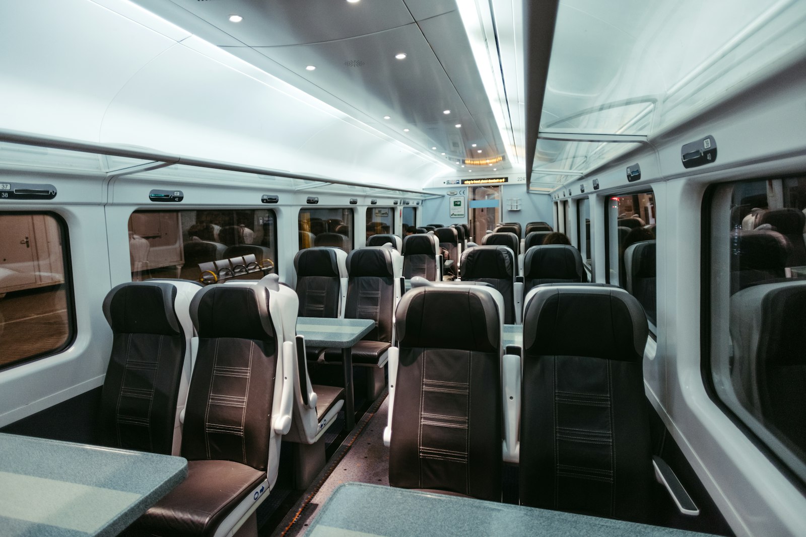 Empty train carriage with rows of numbered seats