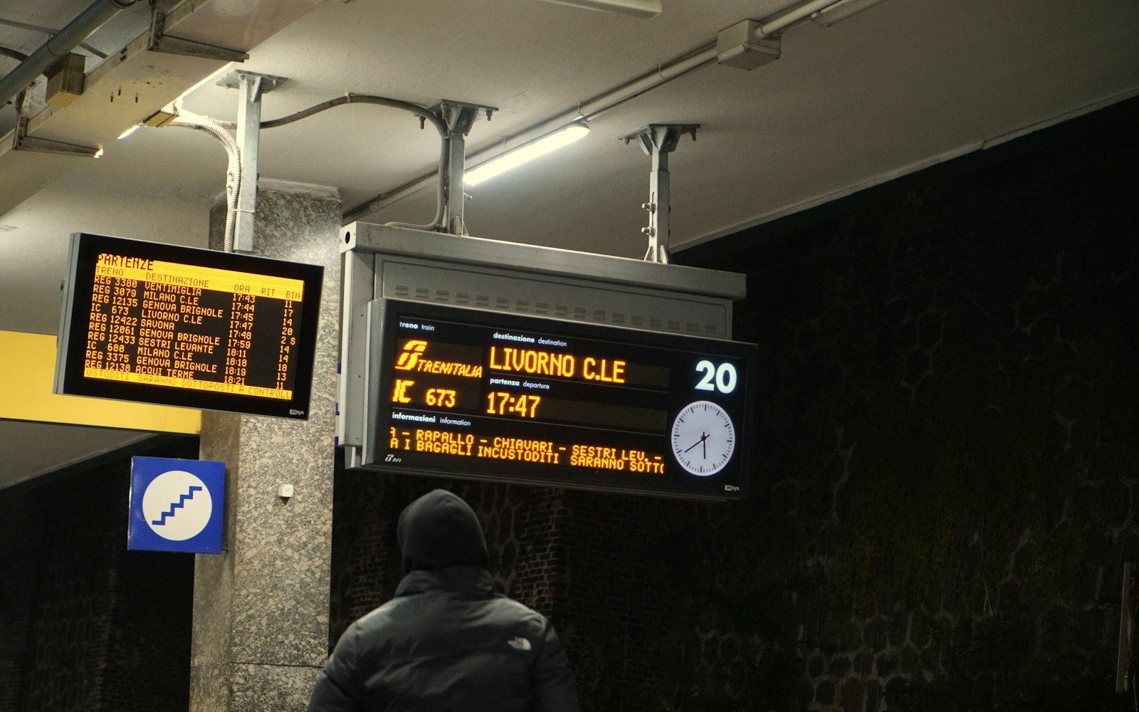 Train departure board showing services at a station concourse