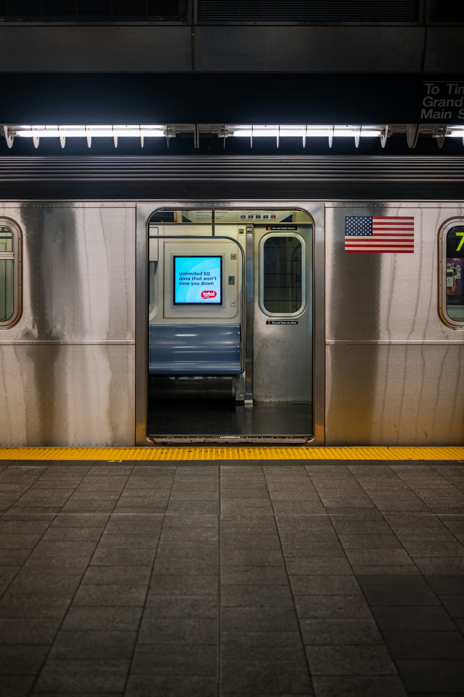 Train stopped with its door open onto the station platform
