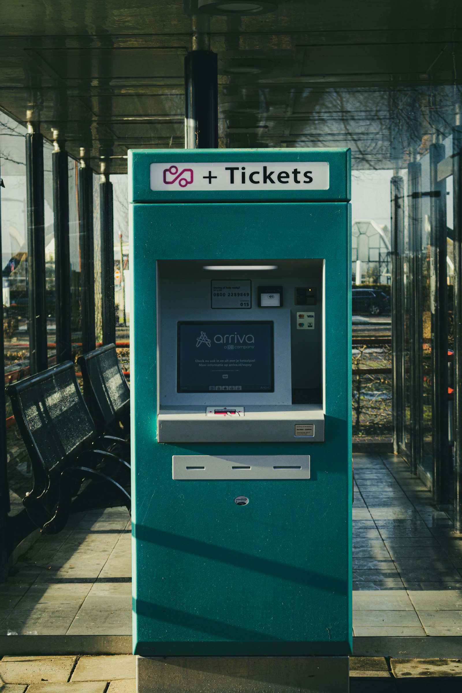 Self-service ticket machine beside a railway platform