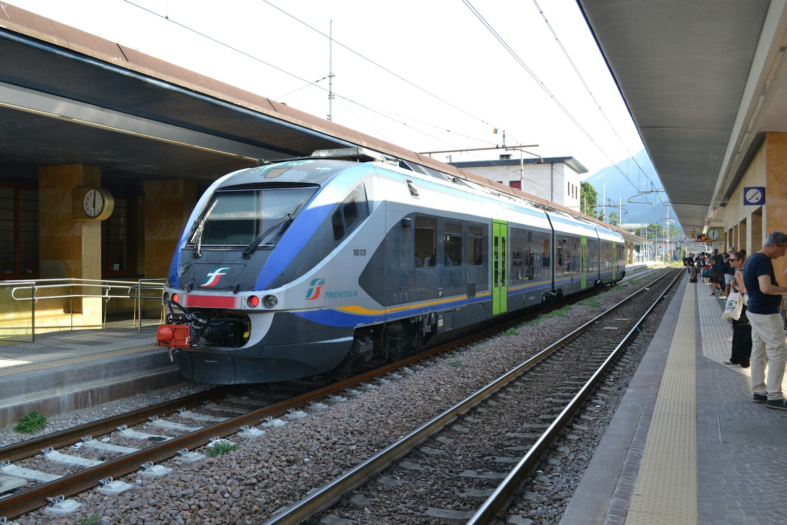 Train stopped at an Italian station platform ready for boarding
