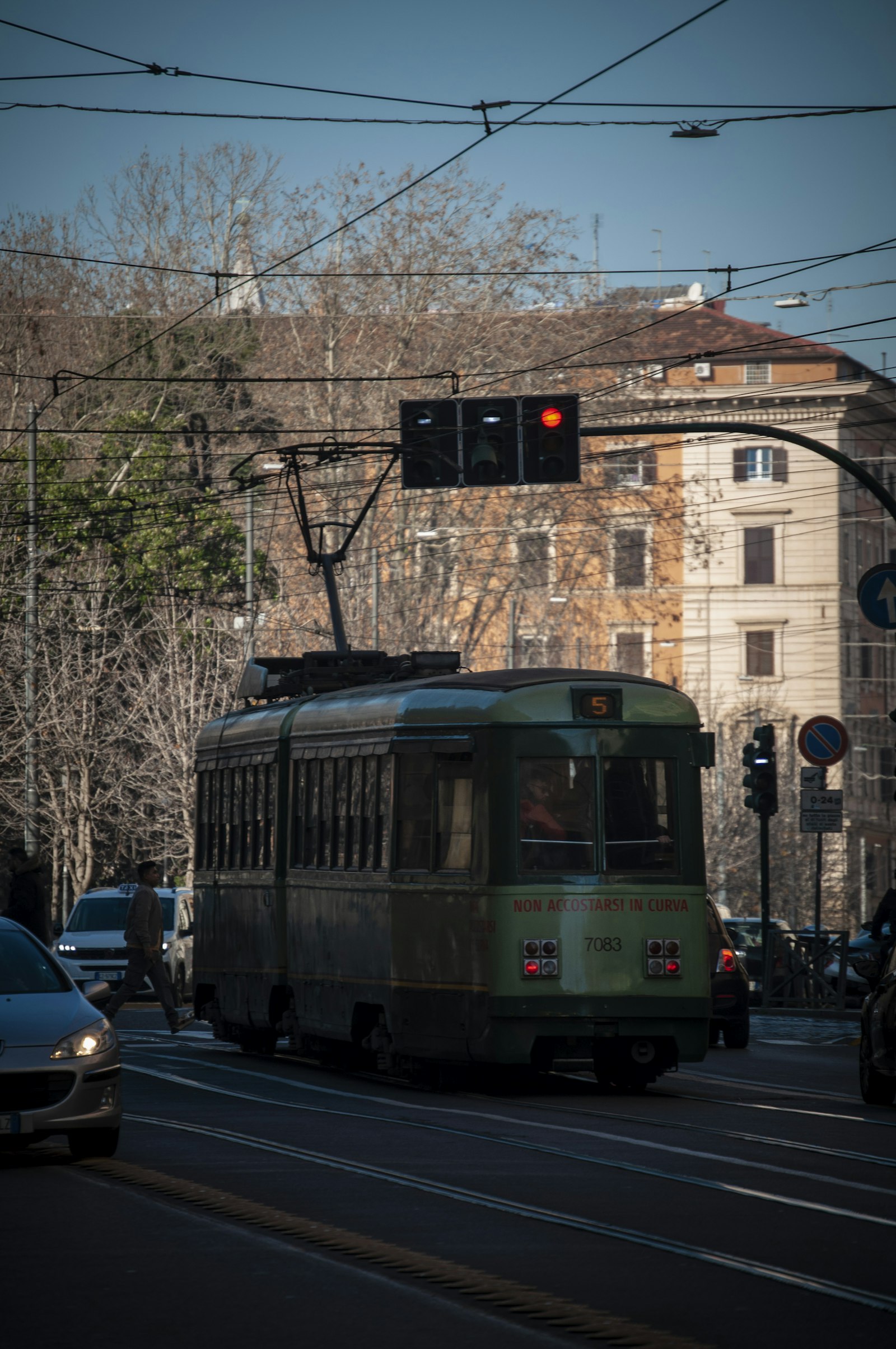 Tram waiting at a traffic light on a city street