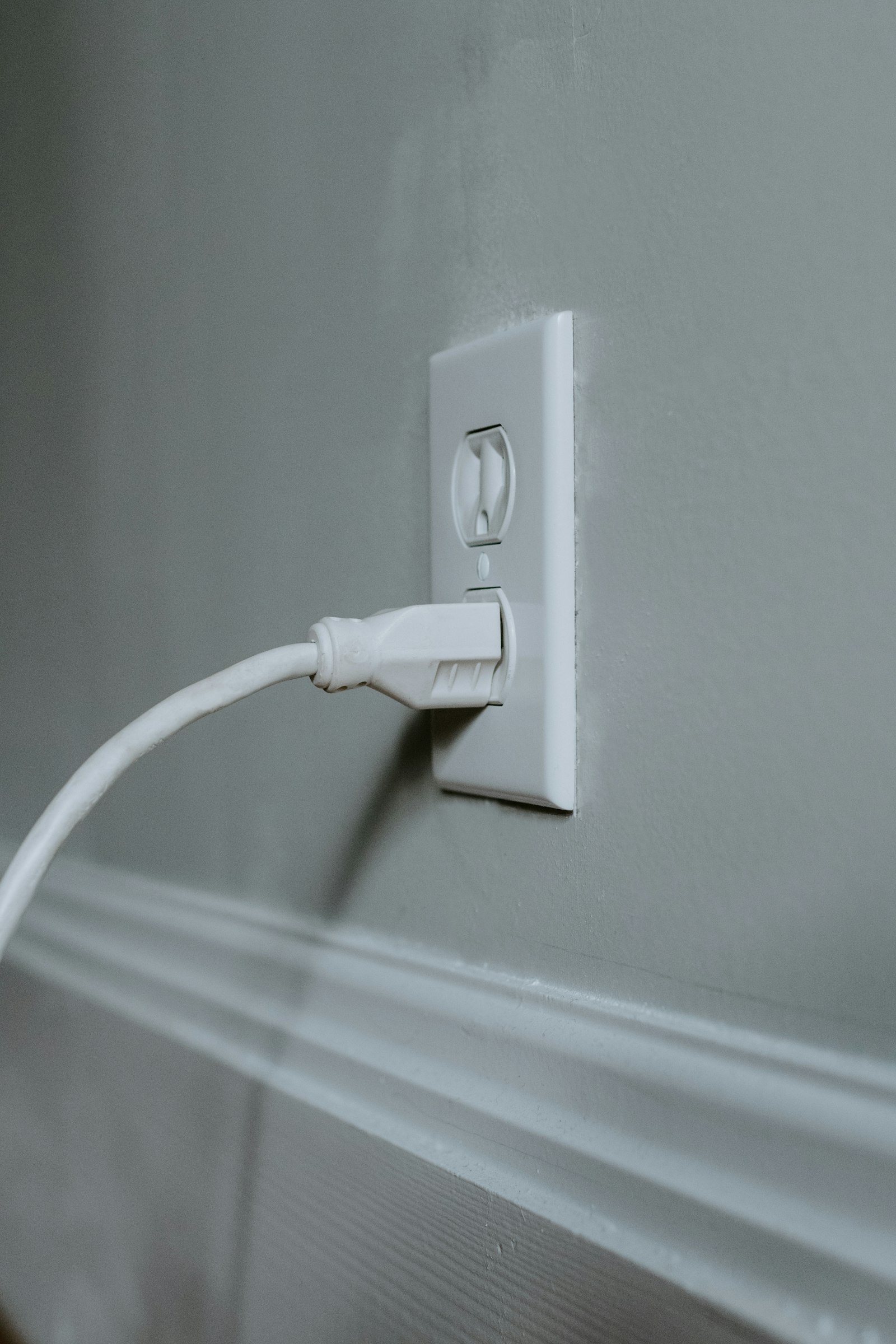 USB charging cable plugged into a European-style wall socket