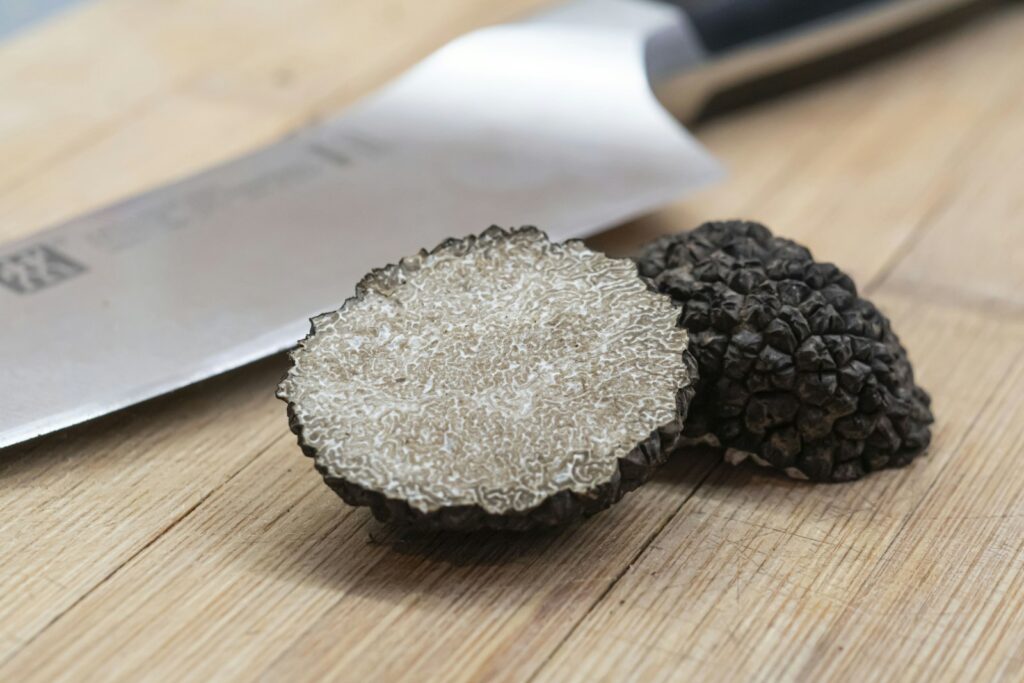 Black truffle sliced on a wooden board