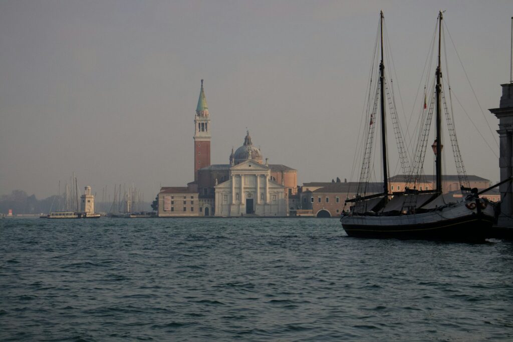 Boats on the Venetian lagoon with a church on the skyline