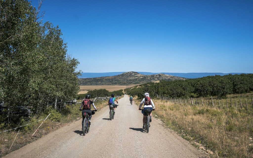 Group of cyclists riding along a country dirt track
