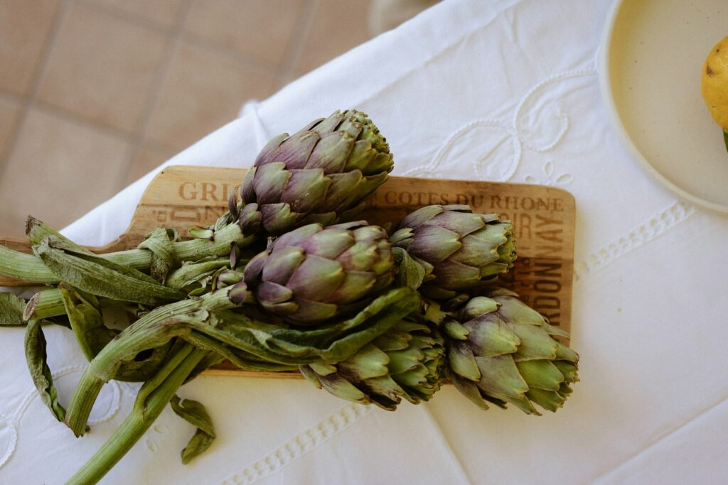 Fresh artichokes on a wooden board