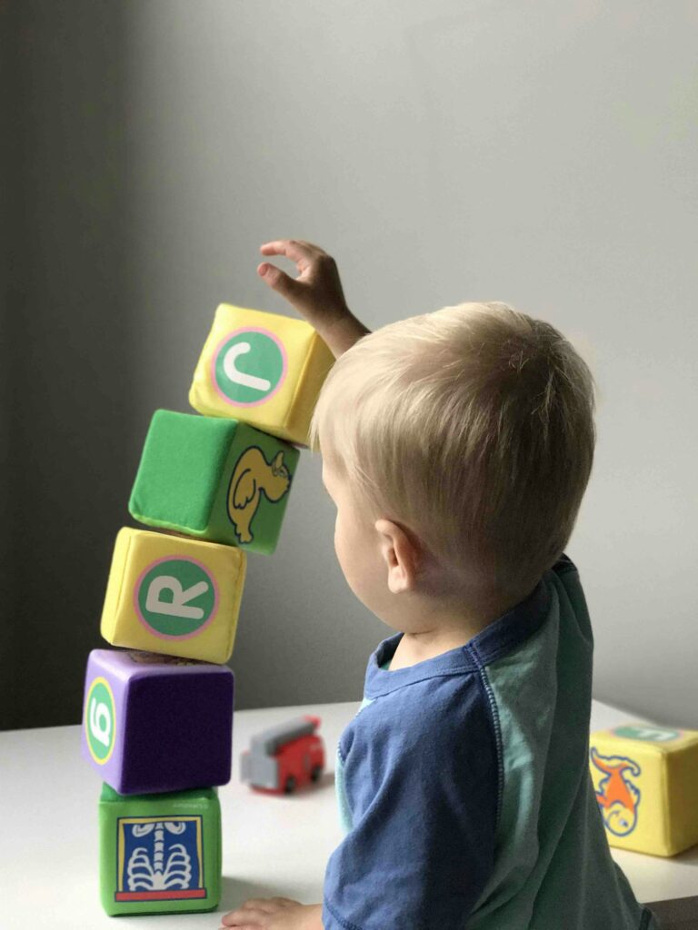 Toddler playing with stacking blocks
