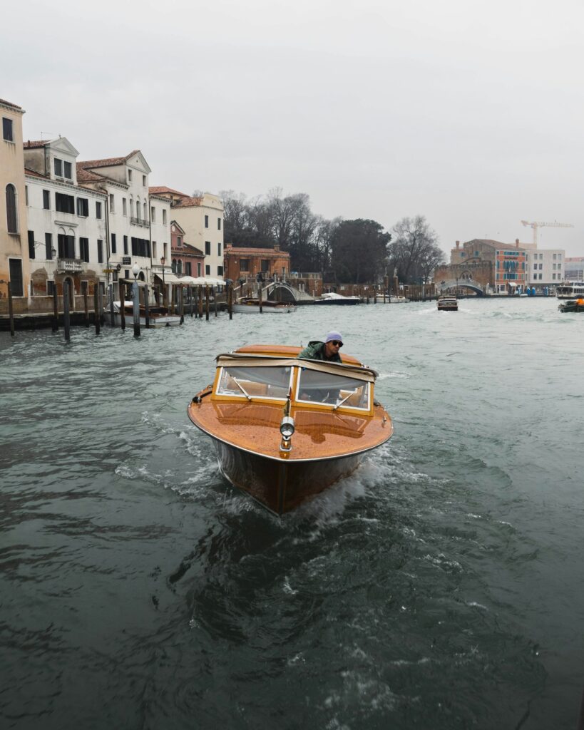Wooden motorboat cruising on a Venice canal
