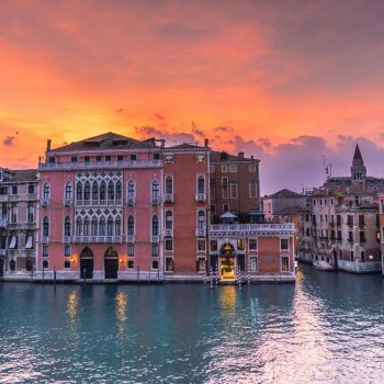 Captivating view of Venice's Grand Canal during sunset showcasing historic architecture and serene waters.